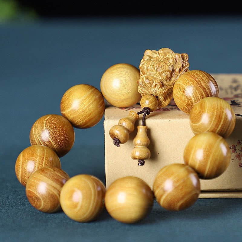 Bracelet de protection sculpté en forme de dragon en bois de santal vert et bois de rose avec petites feuilles de Buddha Stones