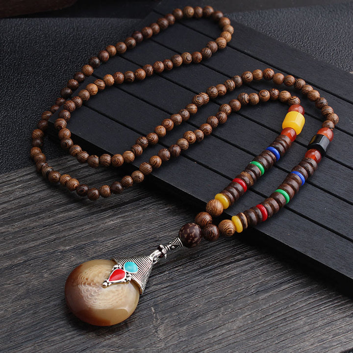 Collier pendentif en Buddha Stones tibétain en bois de wengé Bodhi Seed Agate Balance Peace