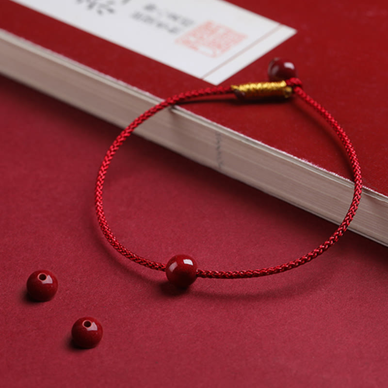 Bracelet en fil rouge avec bénédiction en agate rouge cinabre naturelle de Buddha Stones