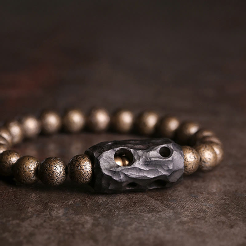 Bracelet de perles en bois d'ébène et cuivre avec Buddha Stones et équilibre