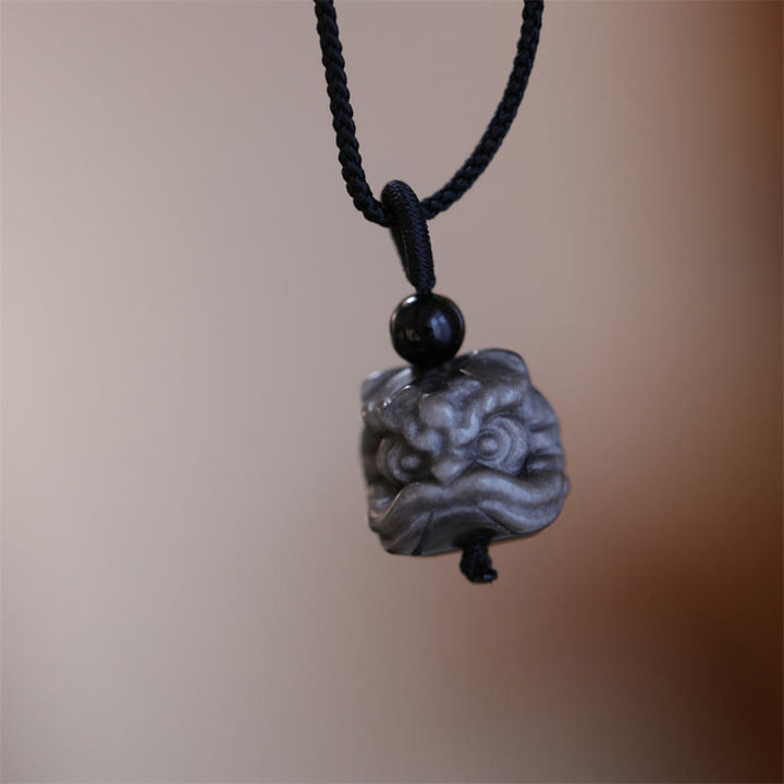 Buddha Stones en obsidienne naturelle argentée et brillante représentant un lion dansant et une protection