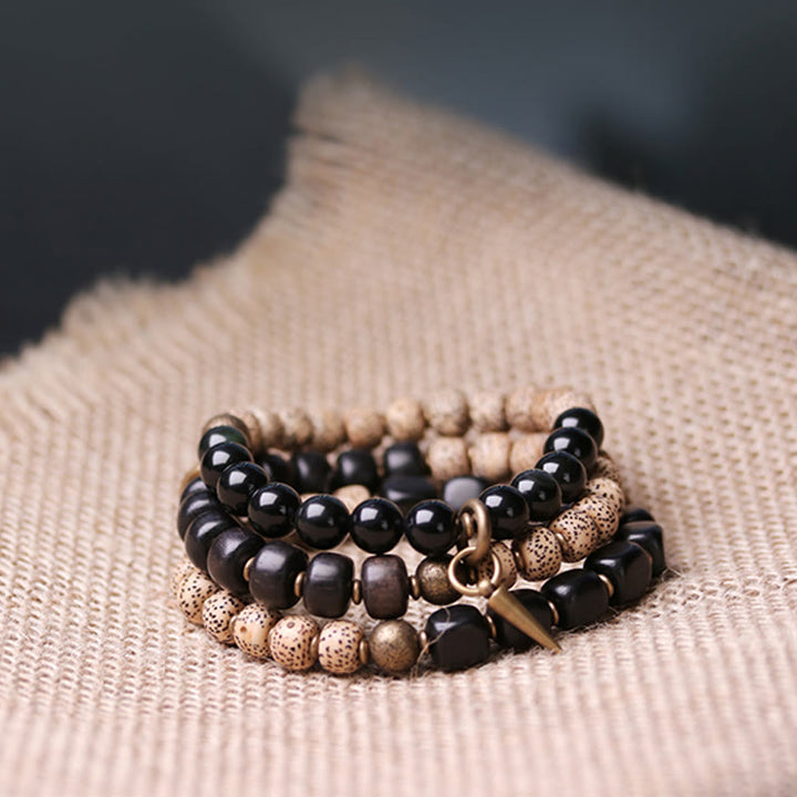 Bracelet de paix en cuivre et bois d'ébène avec Buddha Stones et graines de Bodhi tibétaines