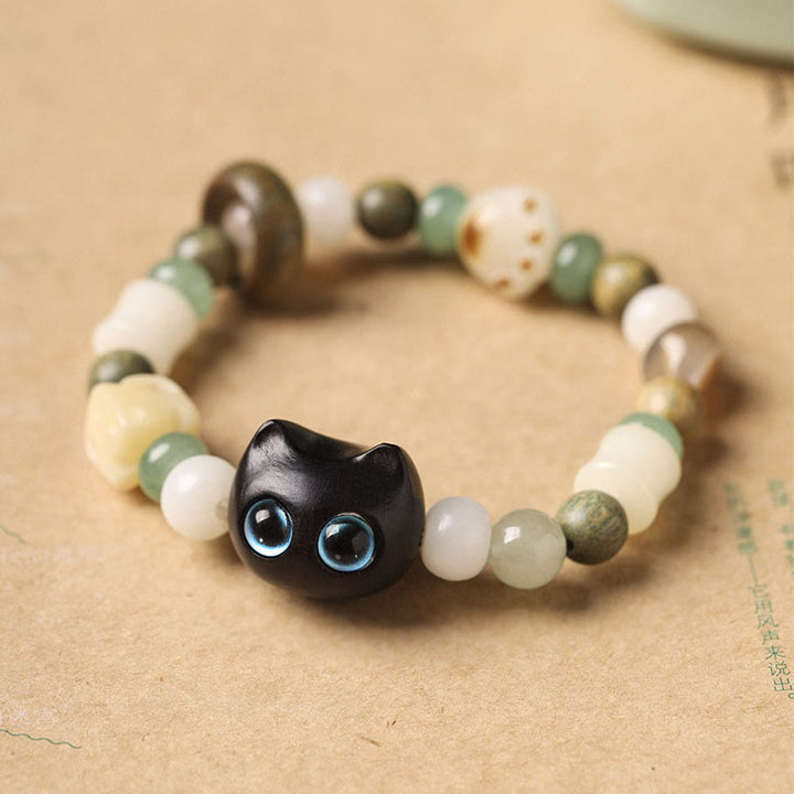 Buddha Stones Graine de Bodhi Bois de santal vert Bois d'ébène Petite feuille Bois de santal rouge Tête de chat Patte Griffe Bracelet de paix - Chat en bois d'ébène (yeux bleus) (tour de poignet 14-16 cm) - image 1