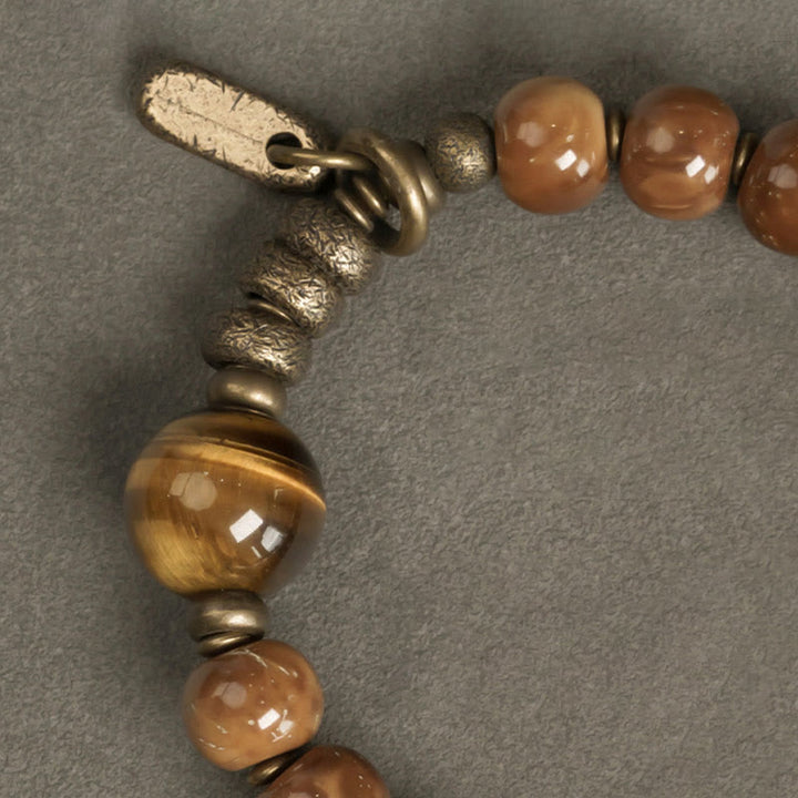 Bracelet porte-bonheur en cuivre et obsidienne dorée avec Buddha Stones de Kuka et œil de tigre