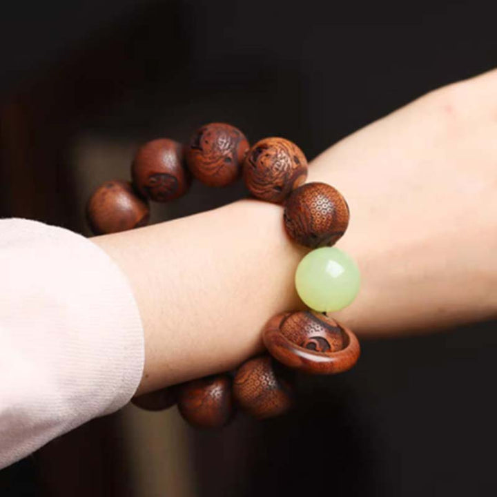 Bracelet de protection du tigre gravé en bois de rose tibétain Buddha Stones