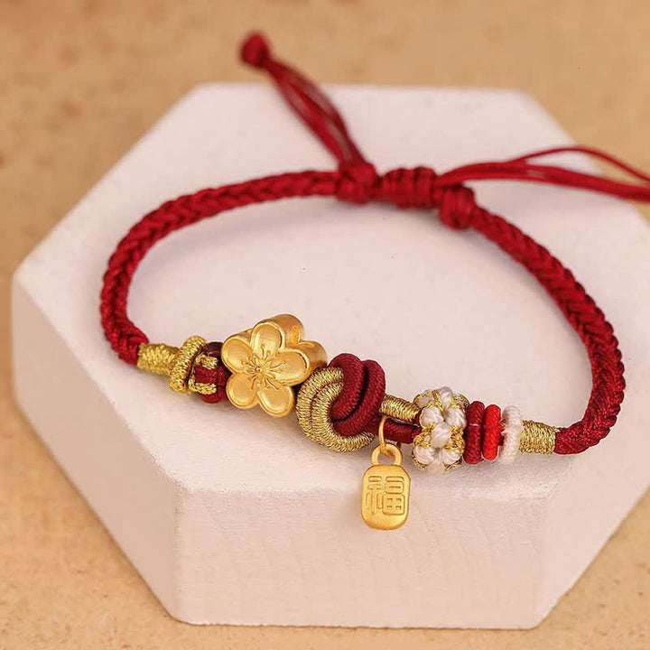 Bracelet porte-bonheur en fil rouge avec Buddha Stones et fleur de pêcher