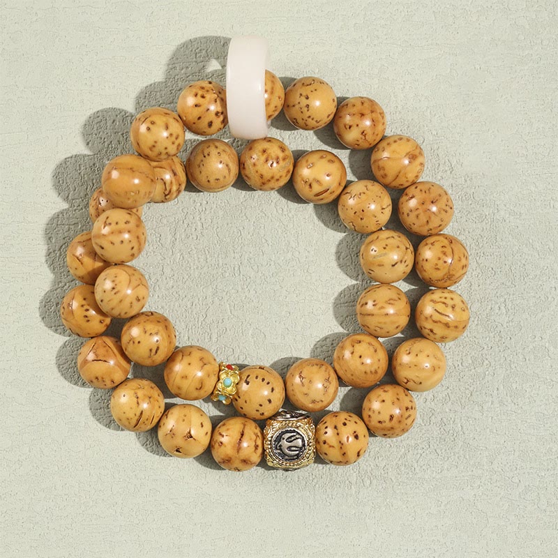 Bracelet double tour en Buddha Stones tibétaines naturelles violettes et dorées avec graines de Bodhi et de richesse