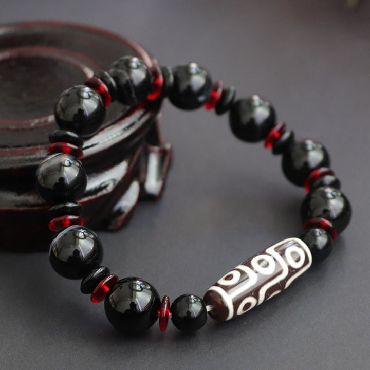 Bracelet de protection de richesse en perles dzi à neuf yeux en onyx noir de Buddha Stones