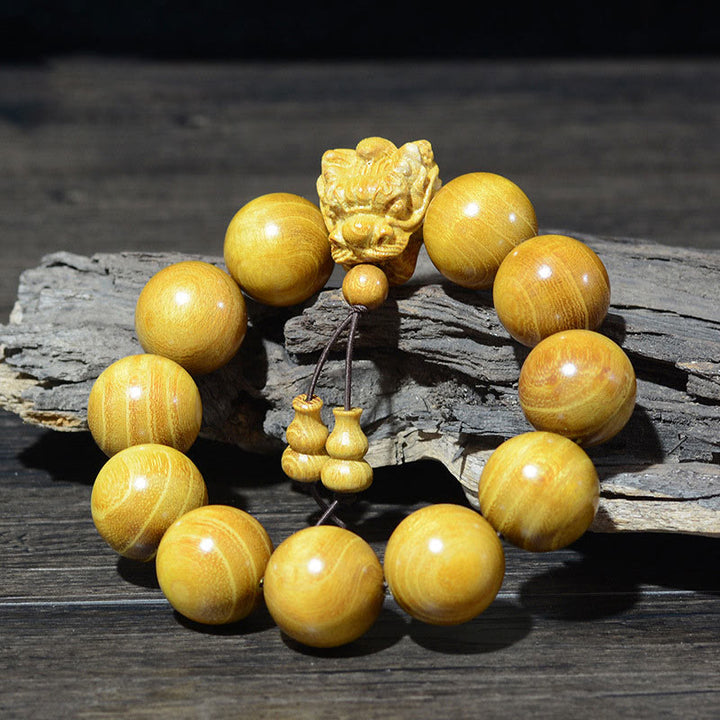 Bracelet de protection sculpté en forme de dragon en bois de santal vert et bois de rose avec petites feuilles de Buddha Stones