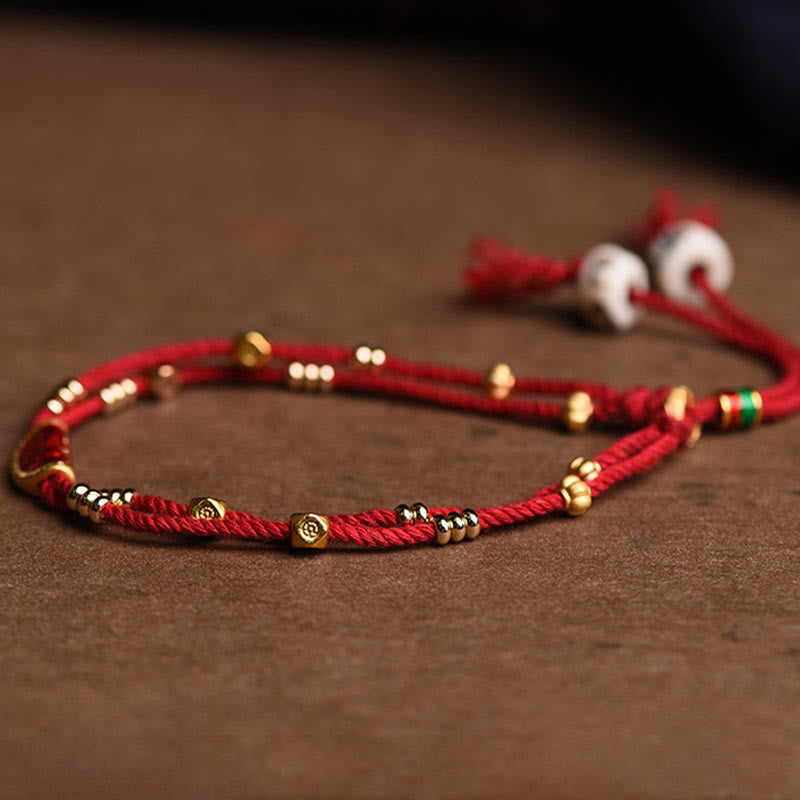 Bracelet en corde rouge tressée porte-bonheur en forme de boulettes de cinabre faites à la main par Buddha Stones