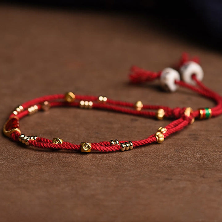 Bracelet en corde rouge tressée porte-bonheur en forme de boulettes de cinabre faites à la main par Buddha Stones