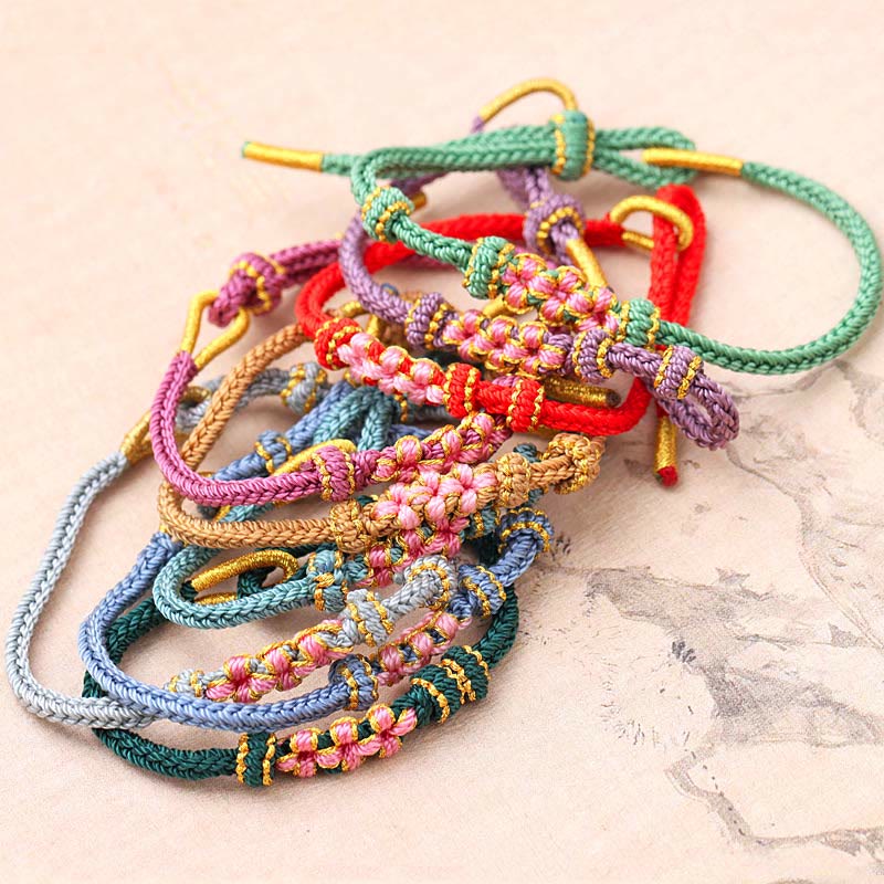 Bracelet tressé fait main à huit brins avec trois fleurs de pêcher et Buddha Stones