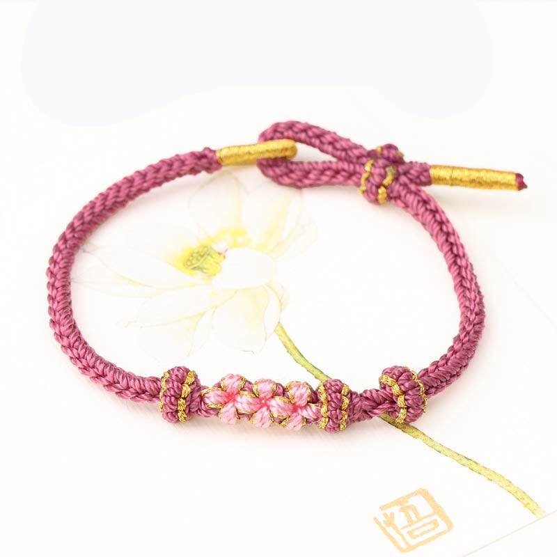 Bracelet tressé fait main à huit brins avec trois fleurs de pêcher et Buddha Stones