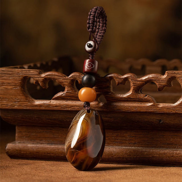 Porte-clés positif en pierre de sardonyx aléatoire Buddha Stones