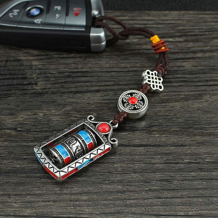 Porte-clés décoratif avec nœud rotatif et bénédiction en forme de roue de prière en six mots vrais en Buddha Stones