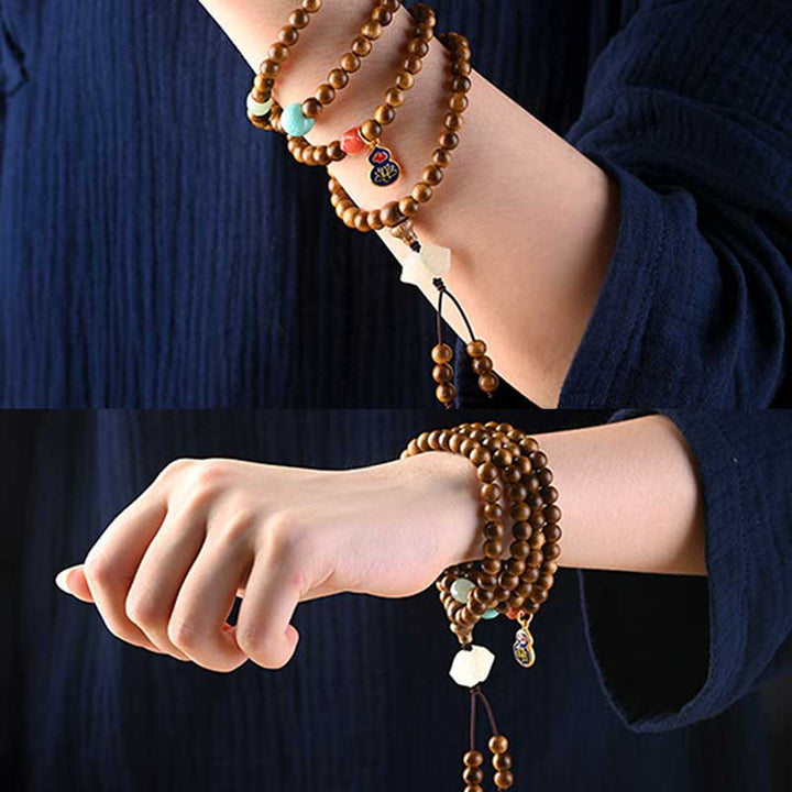Bracelet Mala tibétain de protection et de calme en bois de rose avec Buddha Stones