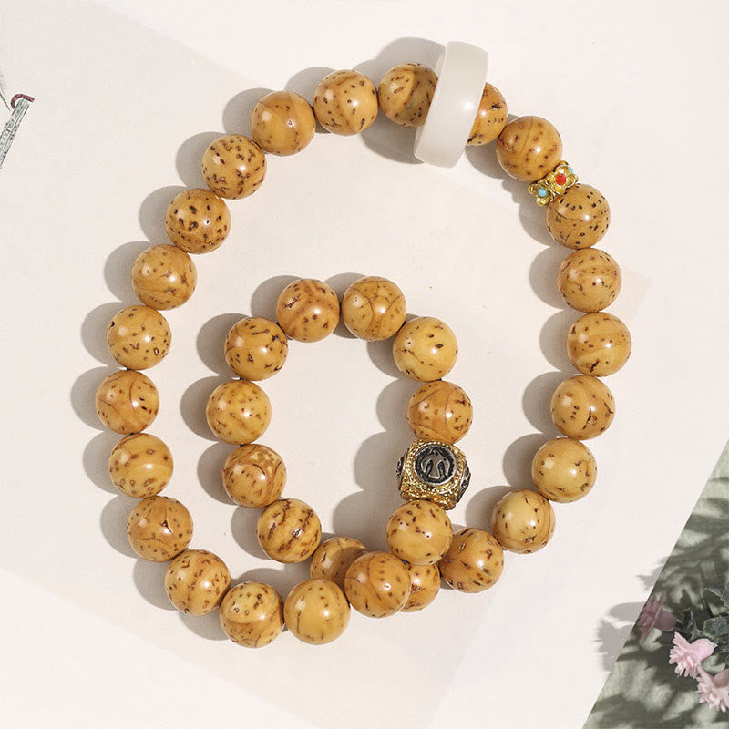 Bracelet double tour en Buddha Stones tibétaines naturelles violettes et dorées avec graines de Bodhi et de richesse