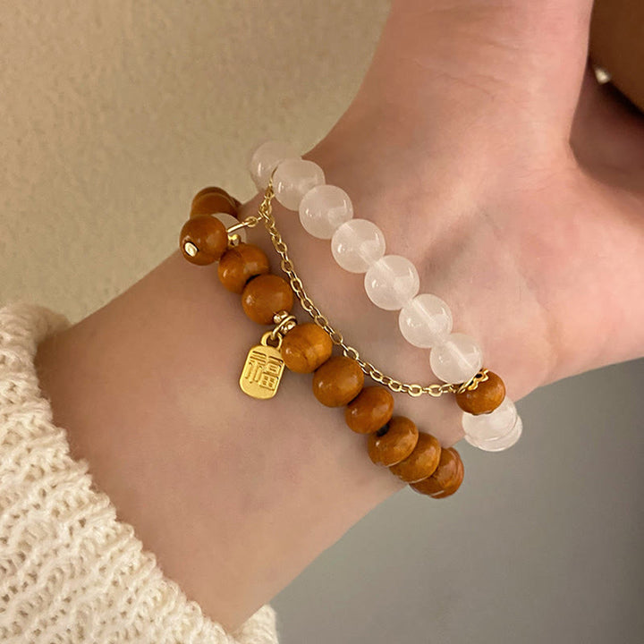 Bracelet de protection à breloques en bois de santal et œil de chat Fu avec Buddha Stones