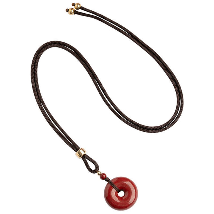 Collier avec pendentif en pierre de cinabre et boucle de paix en Buddha Stones