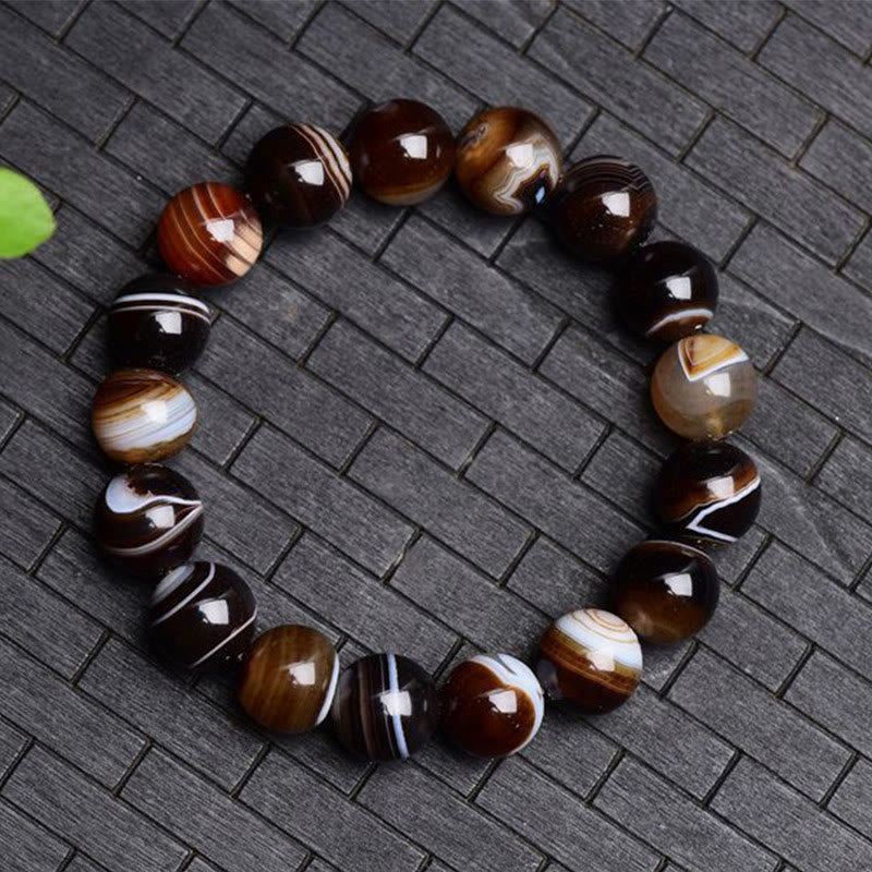 Bracelet de bonheur positif tibétain en sardonyx Buddha Stones