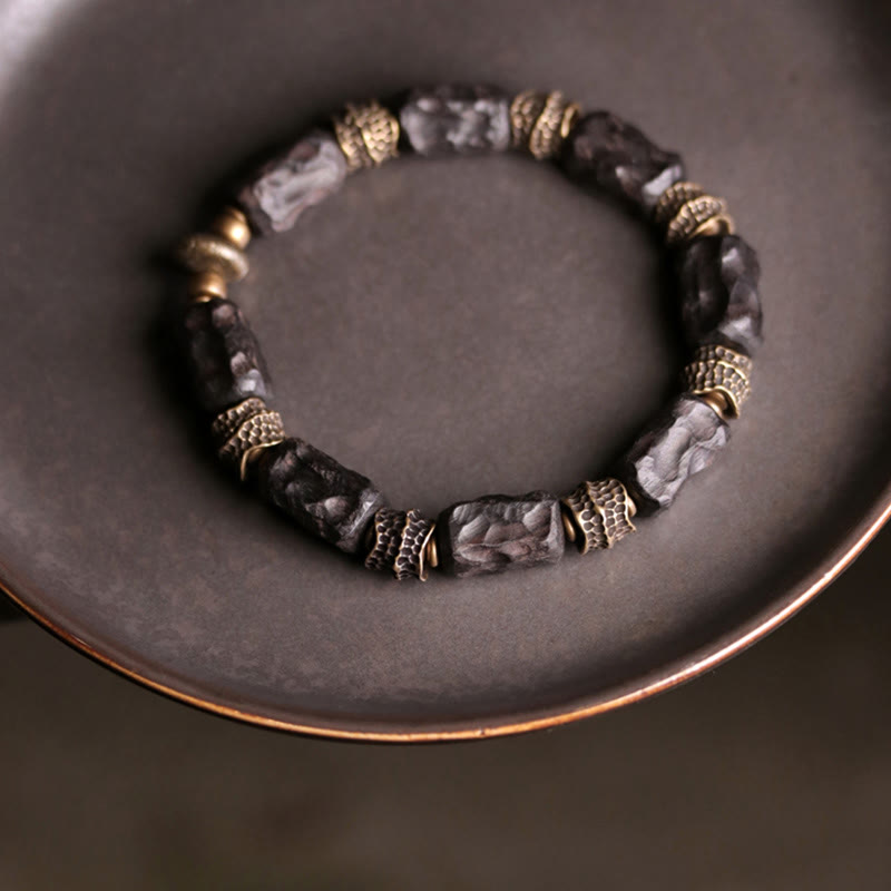 Bracelet tibétain en bois d'ébène et cuivre avec Buddha Stones pour la paix et le calme