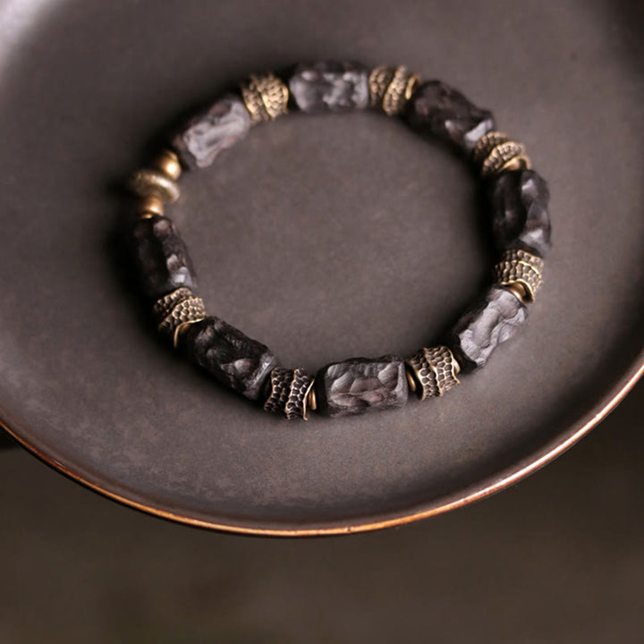Bracelet tibétain en bois d'ébène et cuivre avec Buddha Stones pour la paix et le calme