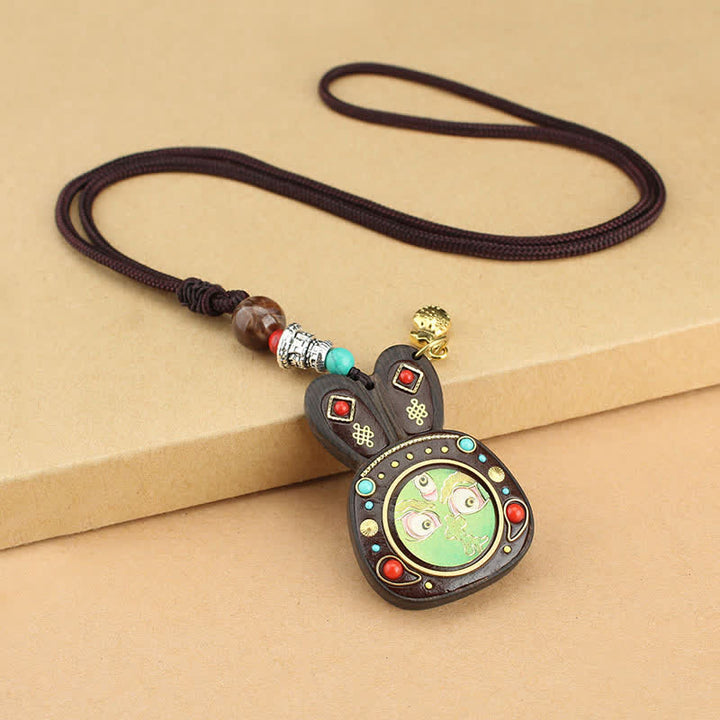 Collier pendentif Thangka en ébène du Tibet représentant les cinq dieux de la richesse