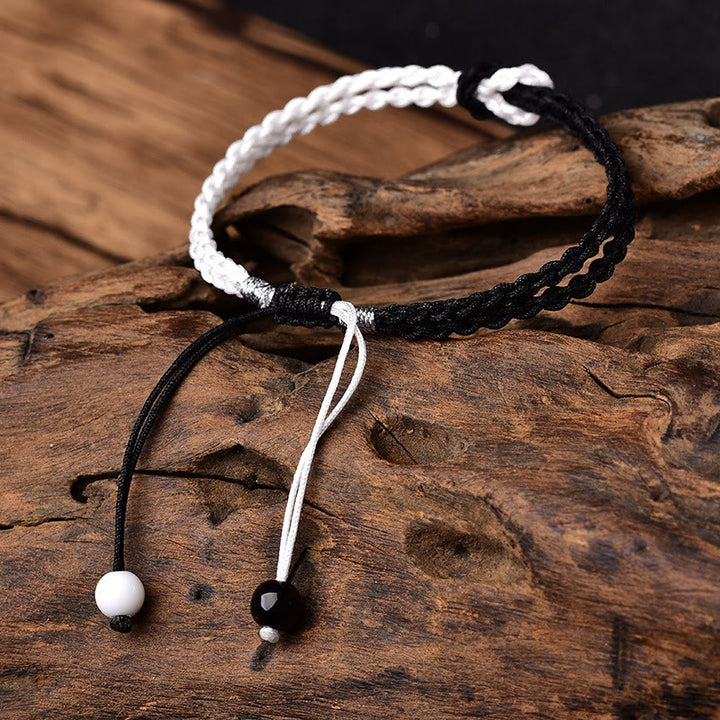 Bracelet de guérison tressé en corde noire et blanche fait main avec Buddha Stones