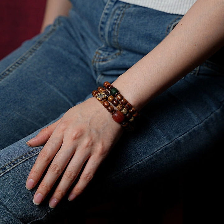 Bracelet triple tour en perles d'ambre et dzi tibétaines en Buddha Stones et graines de Bodhi, perles d'agate et de déesse de la richesse Zakiram