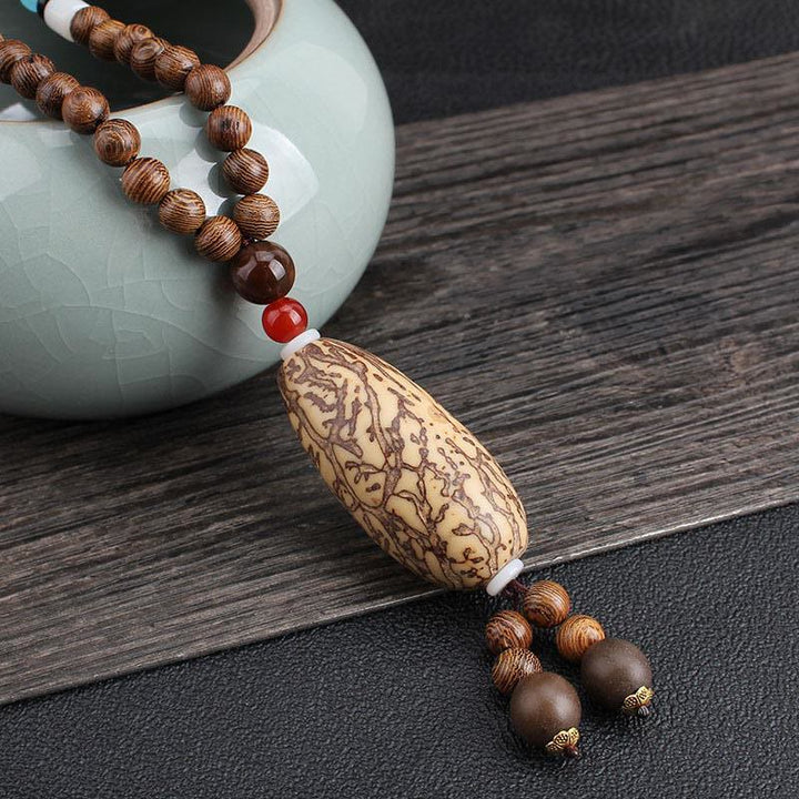 Collier pendentif en Buddha Stones tibétain en bois de wengé Bodhi Seed Agate Balance Peace