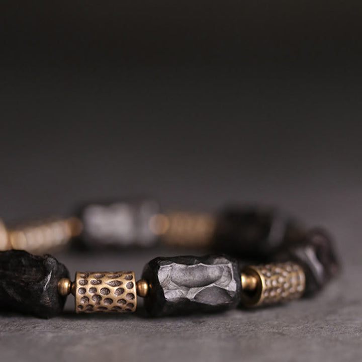 Bracelet tibétain en bois d'ébène et cuivre avec Buddha Stones pour la paix et le calme