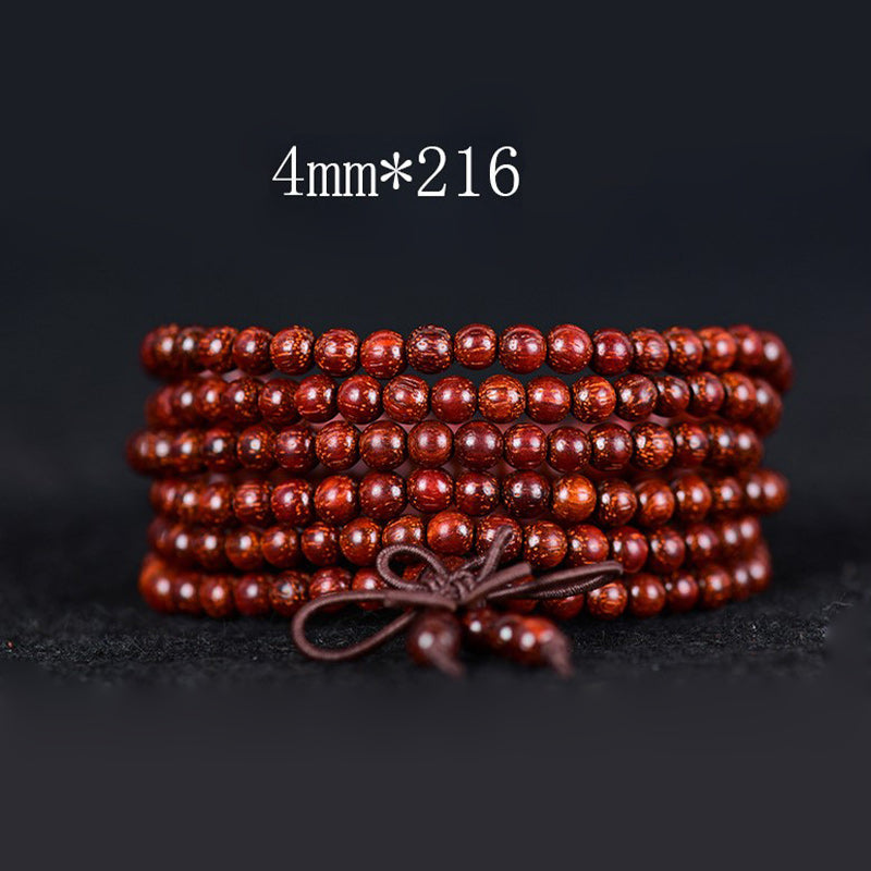 Bracelet d'équilibre tibétain en petites feuilles de santal rouge avec Buddha Stones