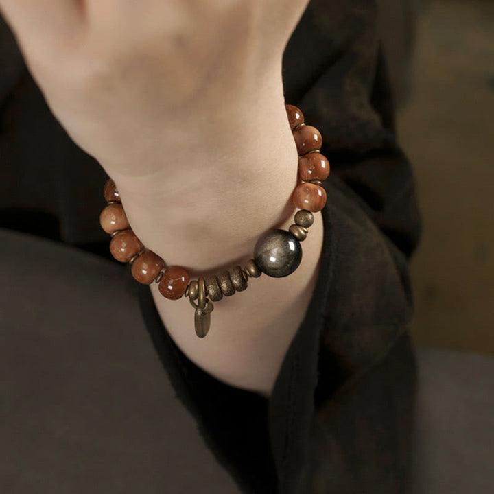 Bracelet porte-bonheur en Buddha Stones, graines de Kuka, œil de tigre, reflets dorés, obsidienne, laiton et cuivre - image 12