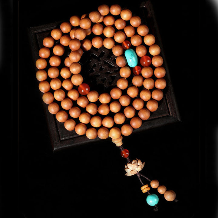 Bracelet Mala à breloques tibétaines en bois de santal et lotus avec Buddha Stones