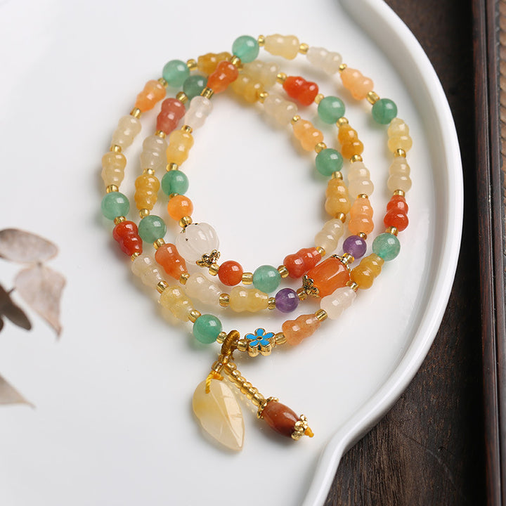 Bracelet de richesse en jade et soie dorée avec Buddha Stones