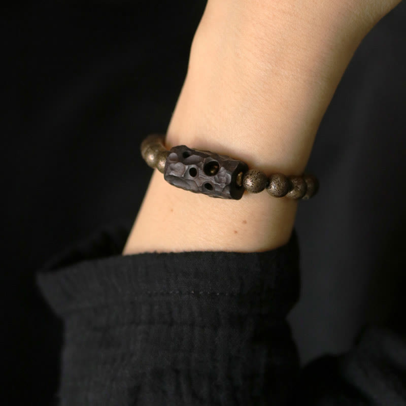 Bracelet de perles en bois d'ébène et cuivre avec Buddha Stones et équilibre