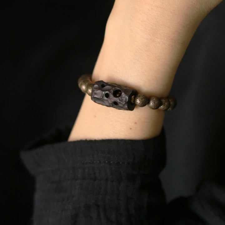 Bracelet de perles en bois d'ébène et cuivre avec Buddha Stones et équilibre
