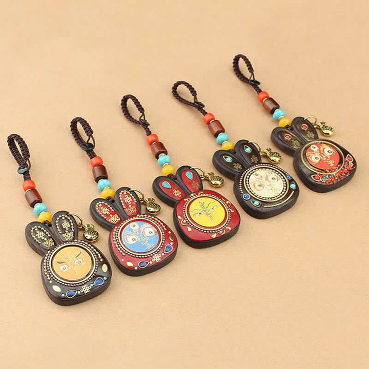 Porte-clés Thangka en ébène du Tibet représentant les cinq dieux de la richesse