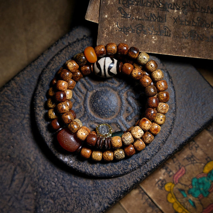 Bracelet triple tour en perles d'ambre et dzi tibétaines en Buddha Stones et graines de Bodhi, perles d'agate et de déesse de la richesse Zakiram