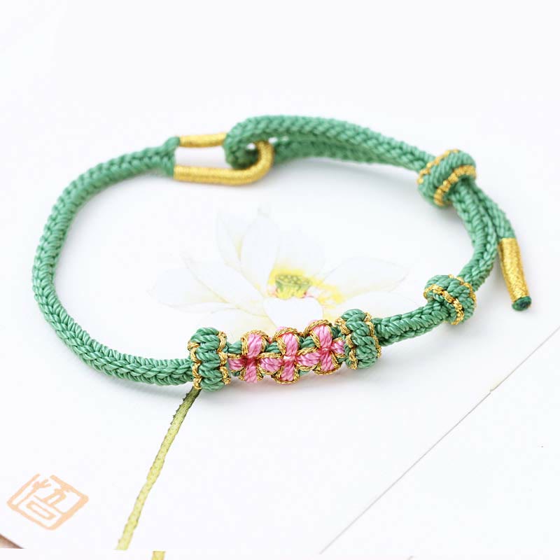 Bracelet tressé fait main à huit brins avec trois fleurs de pêcher et Buddha Stones