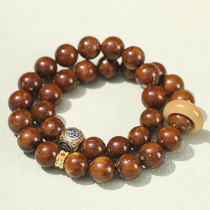 Bracelet double tour en Buddha Stones tibétaines naturelles violettes et dorées avec graines de Bodhi et de richesse