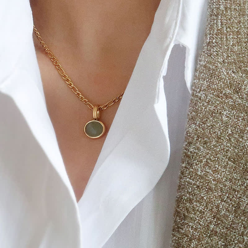 Collier pendentif ovale en acier titane et turquoise