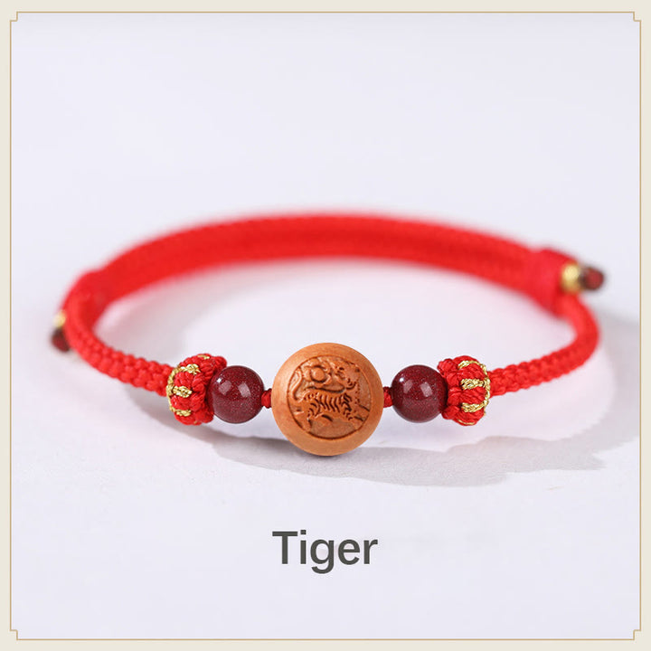 Bracelet de richesse en bois de pêche naturel Buddha Stones et caractère Fu du zodiaque chinois sculpté en cinabre