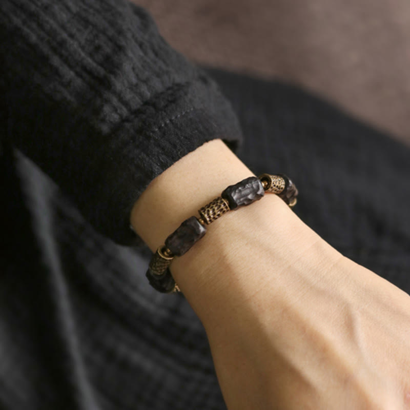 Bracelet tibétain en bois d'ébène et cuivre avec Buddha Stones pour la paix et le calme