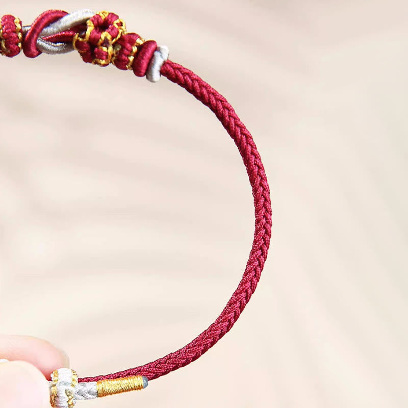 Bracelet de protection porte-bonheur fait main en Buddha Stones avec nœud en fleur de pêcher à huit fils