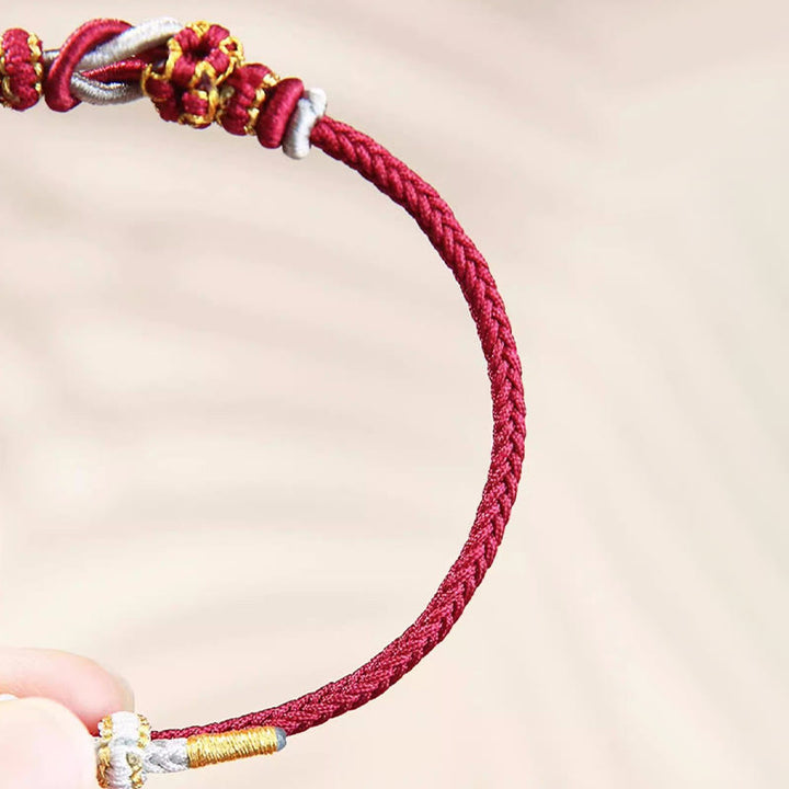 Bracelet de protection porte-bonheur fait main en Buddha Stones avec nœud en fleur de pêcher à huit fils