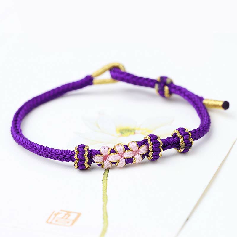 Bracelet tressé fait main à huit brins avec trois fleurs de pêcher et Buddha Stones