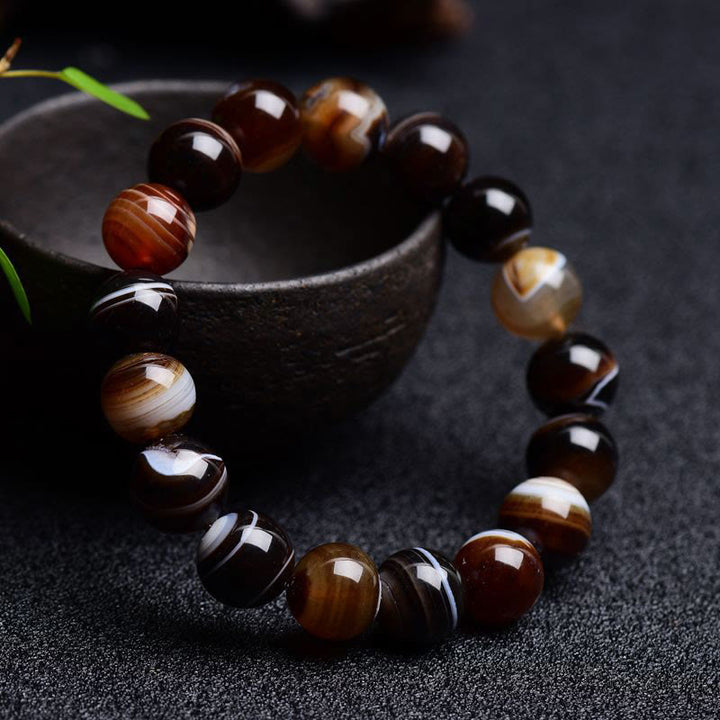 Bracelet de bonheur positif tibétain en sardonyx Buddha Stones