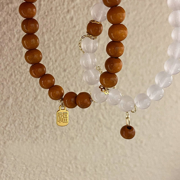 Bracelet de protection à breloques en bois de santal et œil de chat Fu avec Buddha Stones