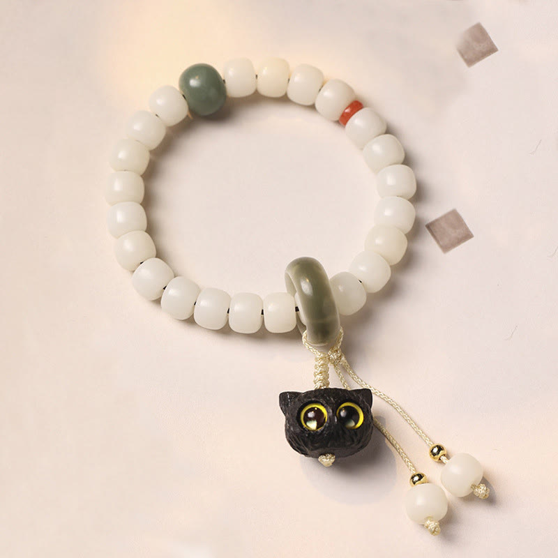 Bracelet en Buddha Stones en graines de Bodhi naturelles en bois noir africain avec joli chat et breloque pour la paix et l'harmonie - Graine de Bodhi du chat aux yeux jaunes - image 1